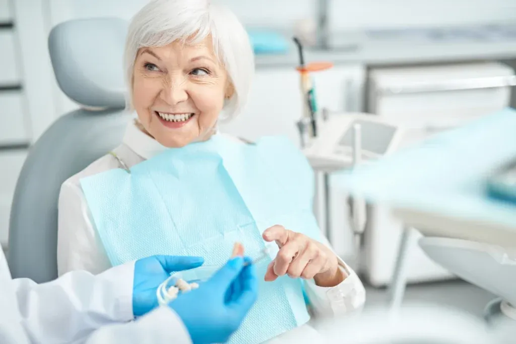Smiling senior patient in the dental chair