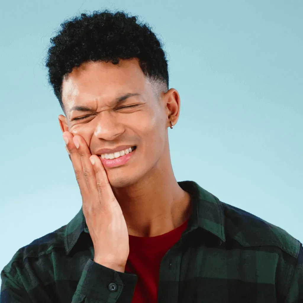 Man holding his jaw because of tooth pain